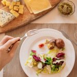 A vibrant lunch setting with salad, cheese, and orange juice, perfect for a healthy meal.