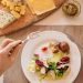 A vibrant lunch setting with salad, cheese, and orange juice, perfect for a healthy meal.